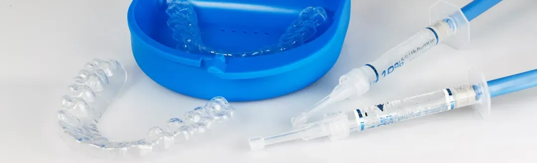 Blue petri dish with liquid and dental instruments on white surface for periodontal research